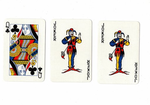A hand of three playing cards isolated on a white background.
