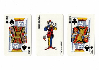A hand of three playing cards isolated on a white background.