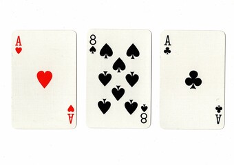 A hand of three playing cards on a white background.