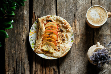 flatbread with peanut butter and apples. Wooden background, side view
