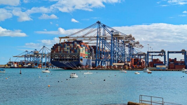 Huge container vessels line pier, container flow fueling commerce pathways, container bustle revealing advanced infrastructure for safe: Birzebbuga, Malta - 01.12.2024