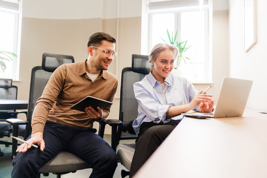 Collaborative meeting between two professionals in a modern office setting during working hours