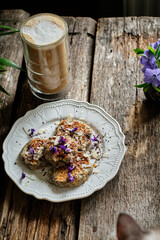 Banana pancakes with chocolate decorated with violets.