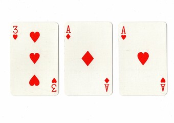 A hand of three playing cards showing a pair on a white background.