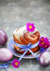 Sweet Easter bread, panettone or cruffin and colorful painted eggs, Holiday spring concept