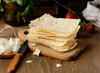 Typical Sardinian carasau bread, healthy, yeast-free and oven-free, with crescenza cheese, cherry...