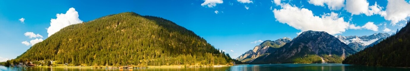 High resolution stitched alpine summer panorama with reflections at Lake Heiterwanger See and Lake Plansee, Heiterwang, Reutte, Tyrol, Austria