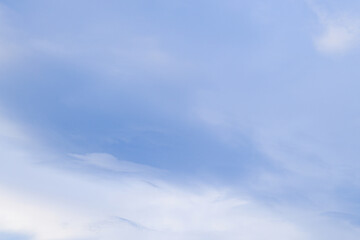 Fototapeta premium Clear blue sky with gentle clouds creating a tranquil atmosphere