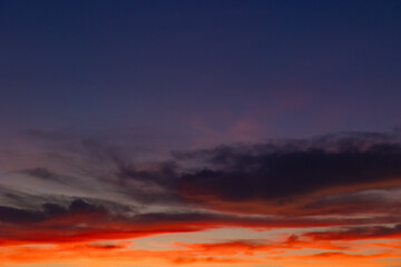 Dramatic sunset scene. Partly cloudy sky with orange clouds