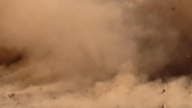 Massive dust and debris cloud, dramatic and chaotic scene, ideal for disaster, action, and cinematic effects. Slow-motion, copy space
