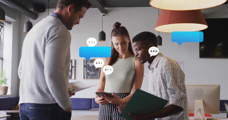 Image of media icons over diverse colleagues discussing work