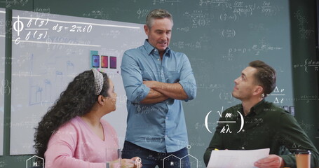 Image of mathematical equations over diverse colleagues discussing work