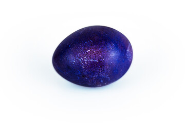 Vibrant purple violet easter egg with  glowing shell pattern, isolated on white background. Color contrast, creativity, holiday decoration, creativity, symbolism of rebirth. Copy space. Selective focu