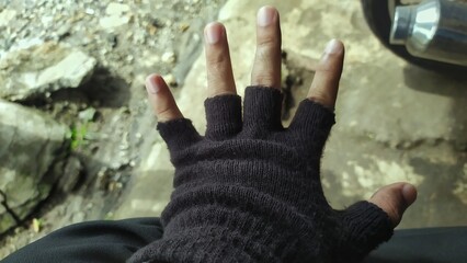 black cloth gloves worn on the hands and still visible fingers