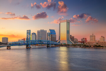 Jacksonville, Florida, USA. Cityscape image of Jacksonville, Florida with reflection of the city skyline in the water at beautiful sunset.