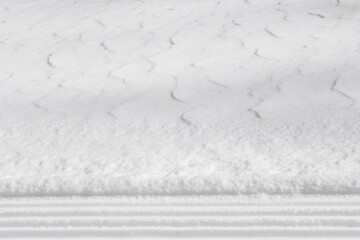 Straight lines in white snow with textured surface background