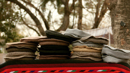 Pakol Hats in Different colors Collectios are display in wall corner, traditional pakol hat on display in lok virsa mela, islamabad 
