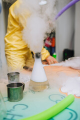 The animator conducts an experiment, a chemical experiment with liquid nitrogen in a flask with a...