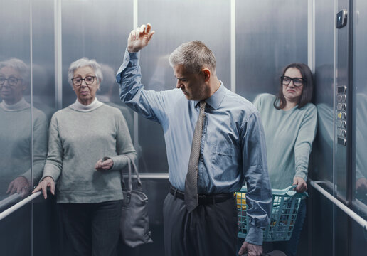 Man with sweaty armpits in a crowded elevator
