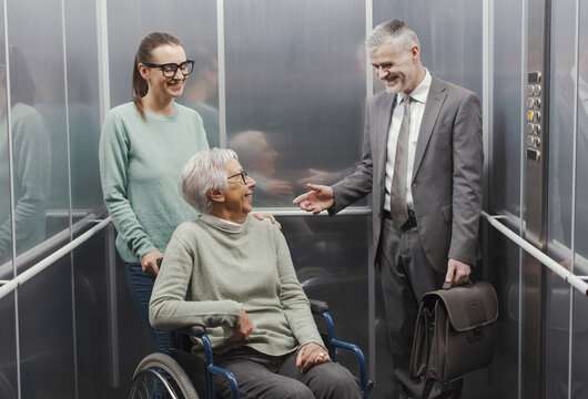 Happy people having a conversation in the elevator