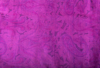 Close up high resolution photo of an vintage hand stitched patchwork silk shawl from India with pink, mauve paisley design