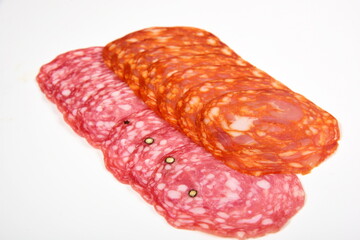 Several Sliced Spanish chorizo sausage isolated on a white  background. Pieces of the chorizo sausage