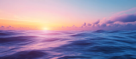 Fototapeta premium Vivid colors of dawn with the sunrise above the ocean The horizon features a sky with clouds and waves A natural background showcasing a gradient of blue and pink Copy space No people present Sunli