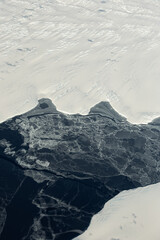 Frozen ice sheet and dark sea of Antarctica.