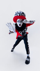 Playful mime artist reaching out with gloved hands, face full of excitement in eccentric circus costume over white background. Concept of circus, theater, performance, show, retro style