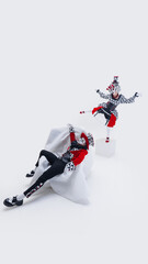 Expressive mime dramatically leaning back in oversized chair, mime performer balances gracefully on...