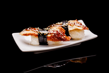 Sushi beautifully arranged on black
