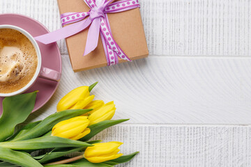 Easter gift box, coffee cup and yellow tulips