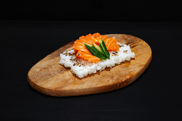 Creative minimalist display of sushi chirashi on a wooden platter against a dark backdrop, emphasizing vibrant colors and exquisite Japanese culinary art with a modern aesthetic.