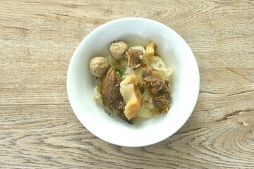 dry boiled thin rice noodles topping slice braised beef meat and tendon with meatball on bowl