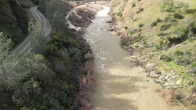 A drone soars over Cache Creek in Rumsey, highlighting the contrast between the water and the surrounding terrain.