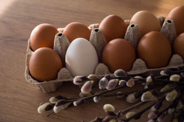Fresh farm eggs in carton box on wooden table. Eggs in egg boxes