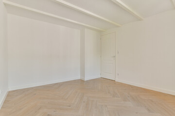 A spacious, minimalist room featuring light-colored walls and natural wood flooring, showcasing a serene and uncluttered environment perfect for relaxation.