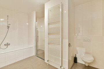 A sleek and contemporary bathroom featuring a shower cubicle, bathtub, and modern fixtures. The neutral palette enhances the clean lines of the space.