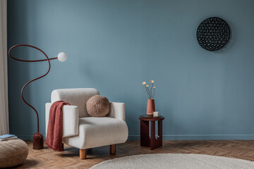 A striking composition featuring a deep blue wall, a sculptural console table, abstract sculptures,...