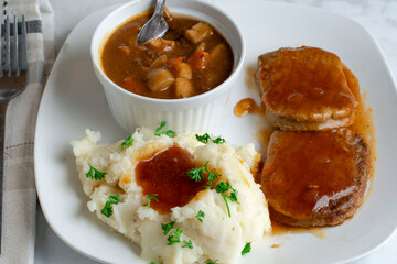 salisbury steak with beef stew  and mashed potatoes