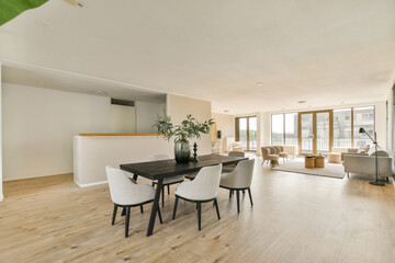 Bright and spacious modern living room featuring minimalist furniture and large windows, creating an airy atmosphere perfect for relaxation.