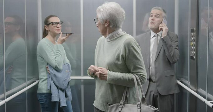 Senior lady annoyed by people talking loudly on the phone