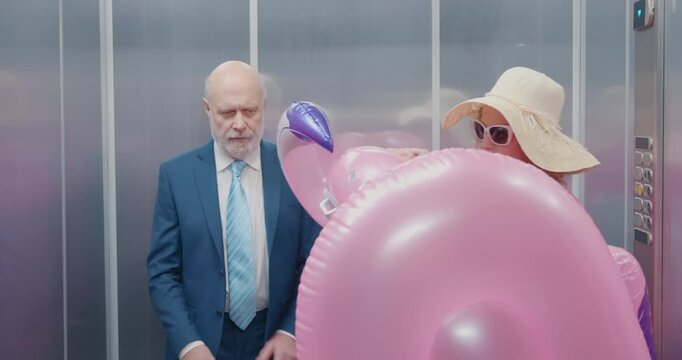 Rude tourist bringing a huge inflatable toy in the elevator