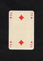 A decorative antique playing card in the suit of diamonds.