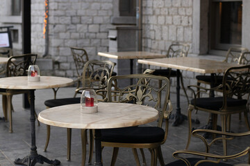 Marble tables with carved chairs in a cozy restaurant.