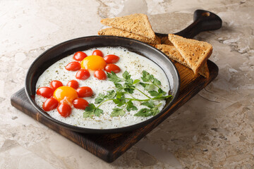 Children's food idea in the form of a flower of fried eggs, cherry tomatoes and parsley close-up in a plate on the table. Horizontal