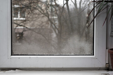 plastic window is fogged up. drops of water gathered on the glass