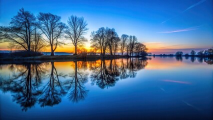 Reflections of twilight on the calm river surface, with silhouetted trees against a fading blue sky, riverbank, river,  riverbank
