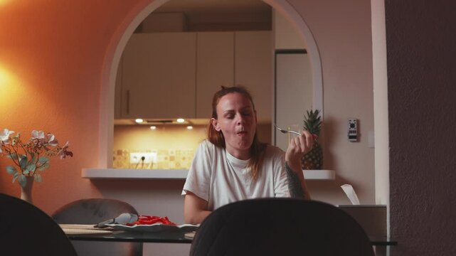 Female enjoying meal, expressing various taste reactions while seated at dining table, sampling dishes with changing facial emotions
