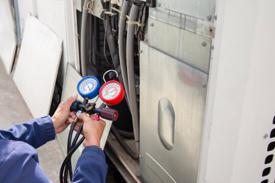 Air conditioner technician checking air conditioner operation	